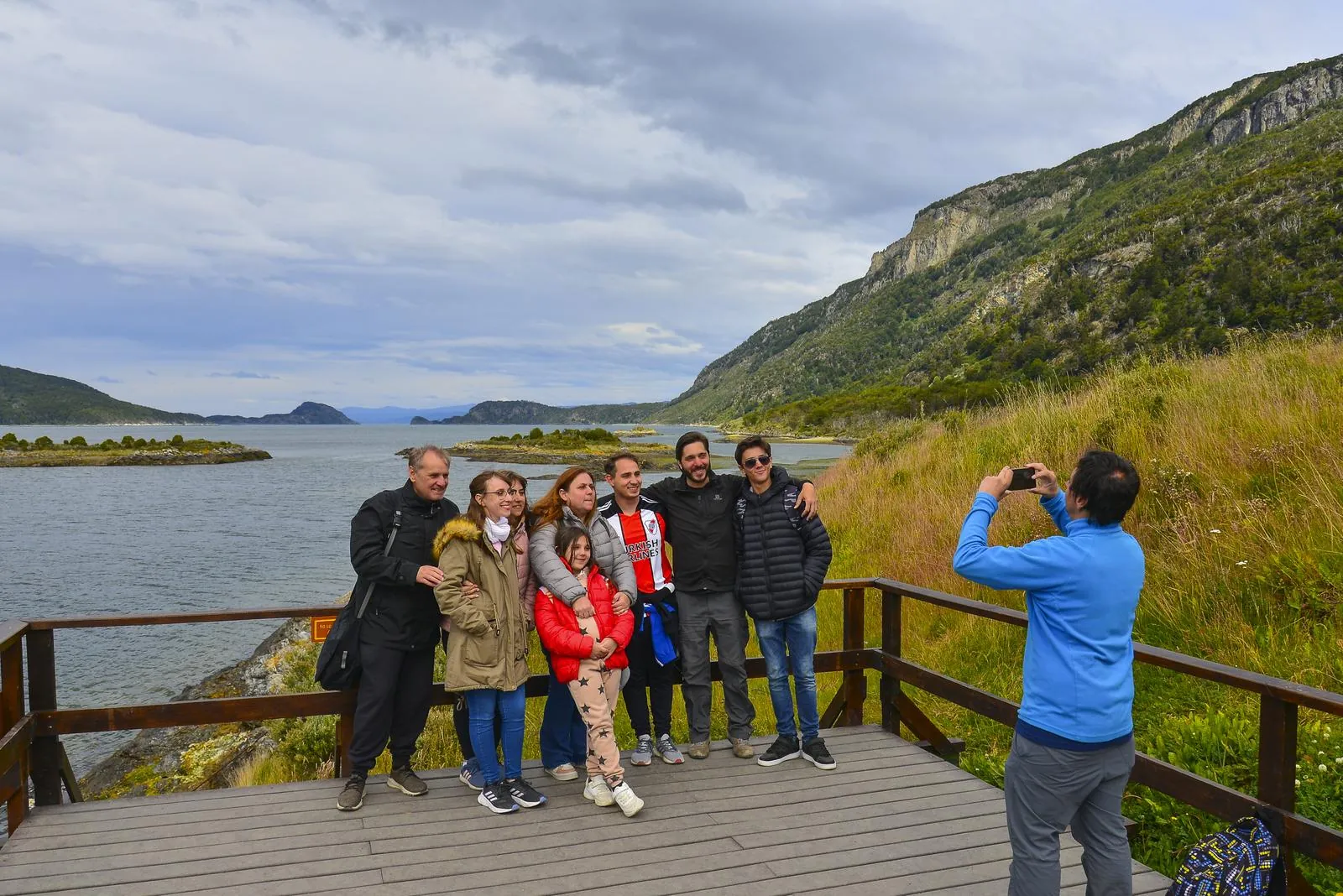 Family group on a viewing deck above the bay