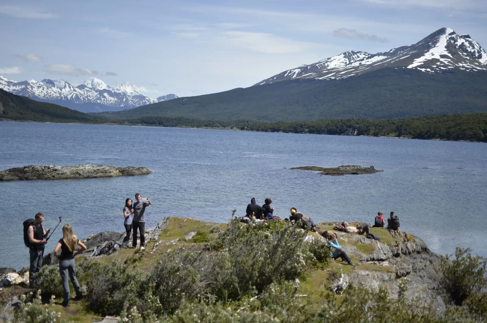 Group resting on a rocky headland above the channel