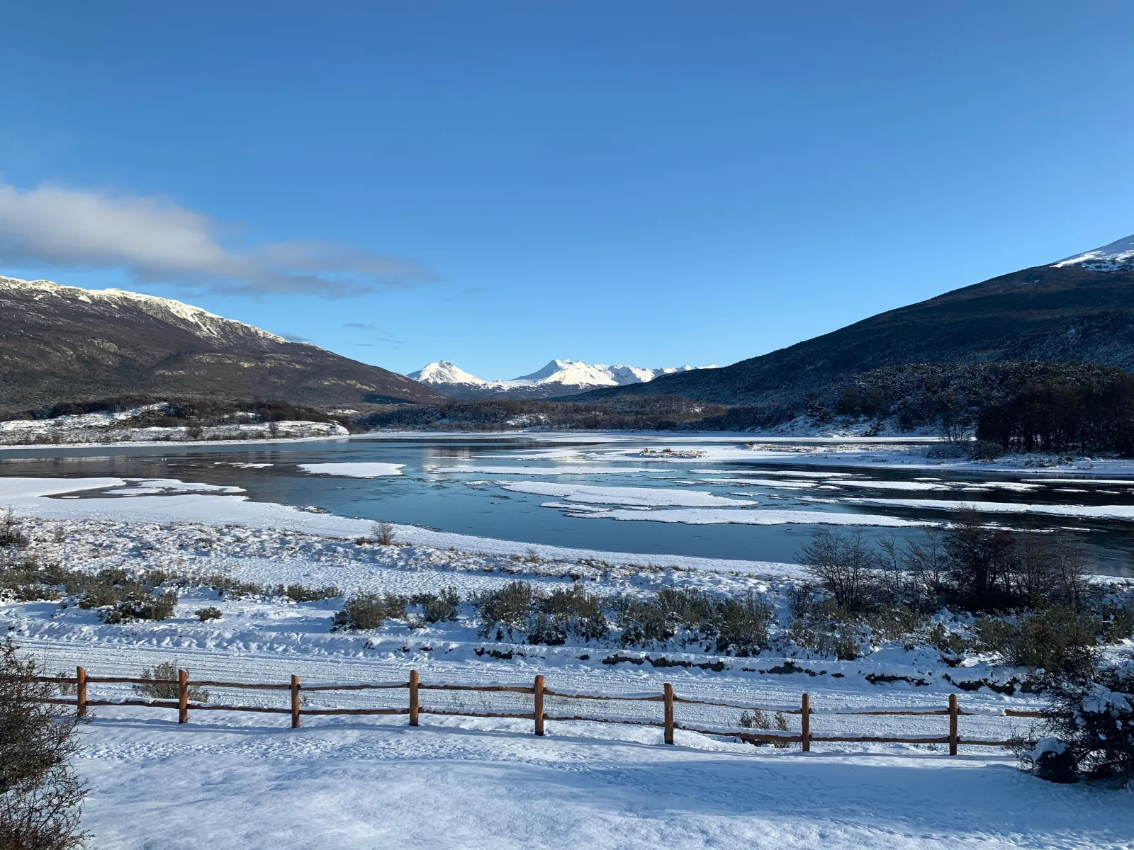 Frozen lagoon and snow-dusted mountains inside Tierra del Fuego National Park