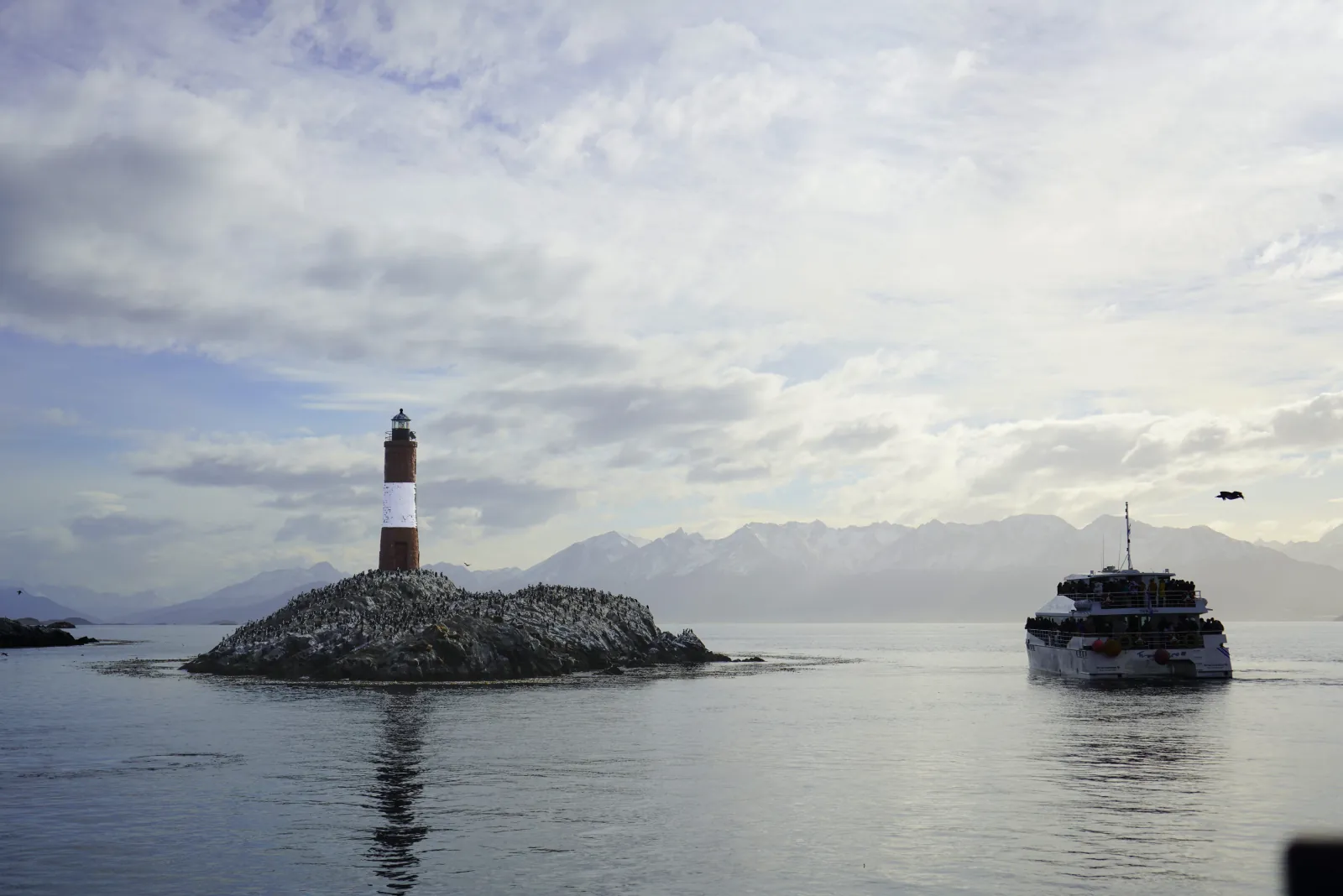 Catamaran passing Les Éclaireurs Lighthouse on the Beagle Channel