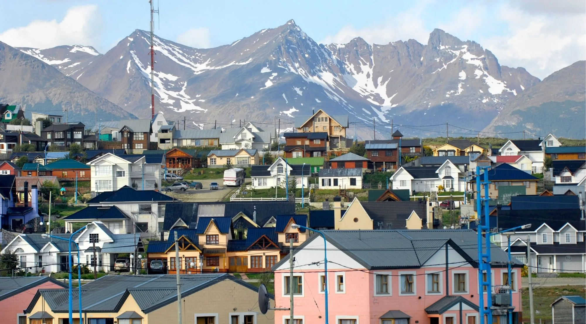 Colourful houses of Ushuaia below snow-streaked mountains